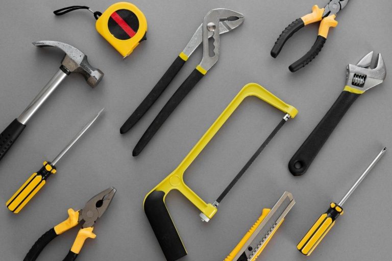 A diverse set of tools, such as pliers and wrenches, organized neatly on a work surface for easy access.
